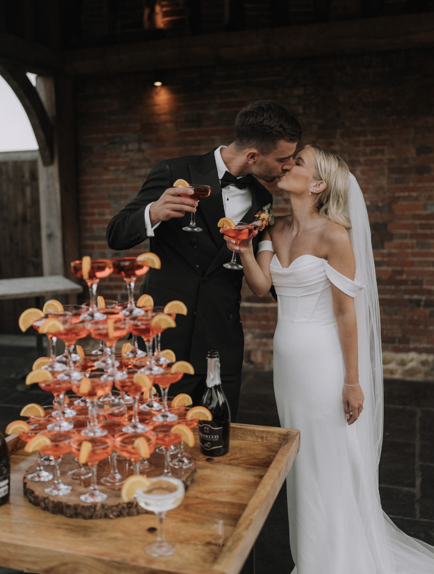 wedding couple at Barns at Redcoats with their Aperol Tower